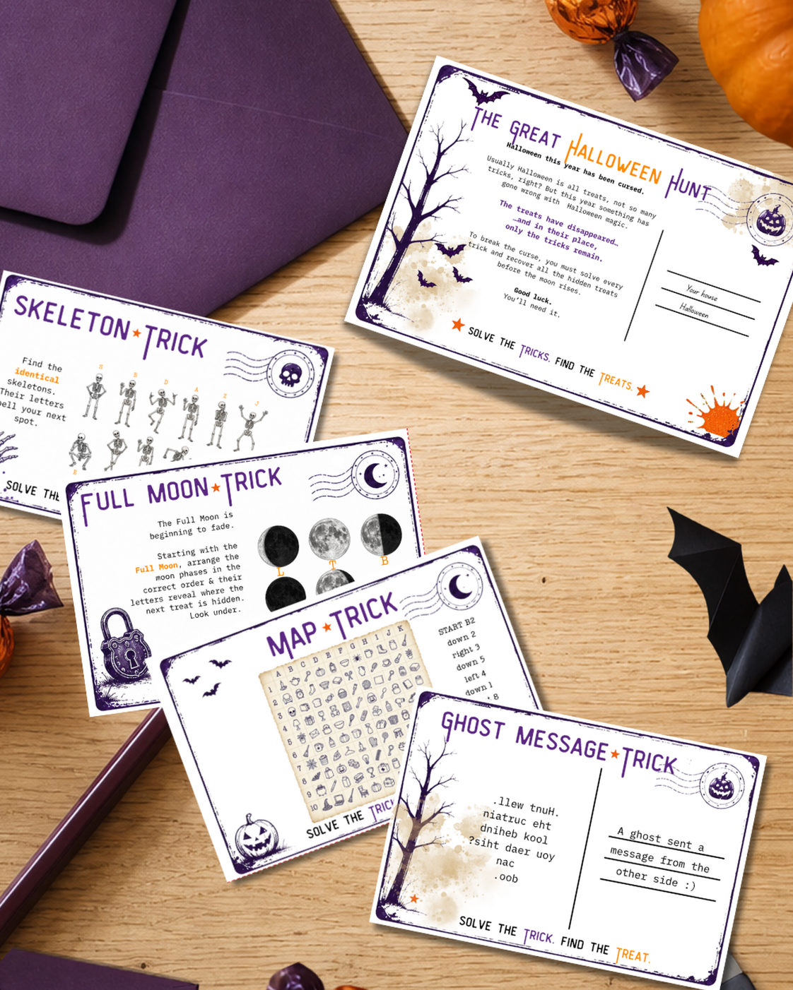 Halloween hunt clue cards on a wooden table with purple envelopes, sweets and seasonal decorations