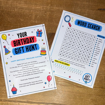 Two printed activity cards for a birthday treasure hunt game, shown on a wooden tabletop. One card reads 'YOUR BIRTHDAY GIFT HUNT' with birthday-themed illustrations, and the other shows a 'WORD SEARCH' grid with a 'TREASURE HUNT' logo.