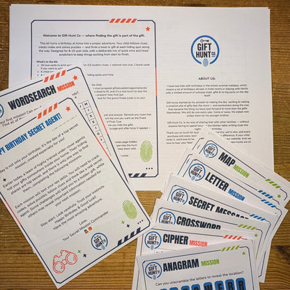 A set of printed gift hunt game cards and a welcome sheet laid out on a wooden surface. The cards include missions such as Word Search, Letter, Cipher, Crossword, and Amagram, with printed text and colorful blue, orange, green, and red accents.
