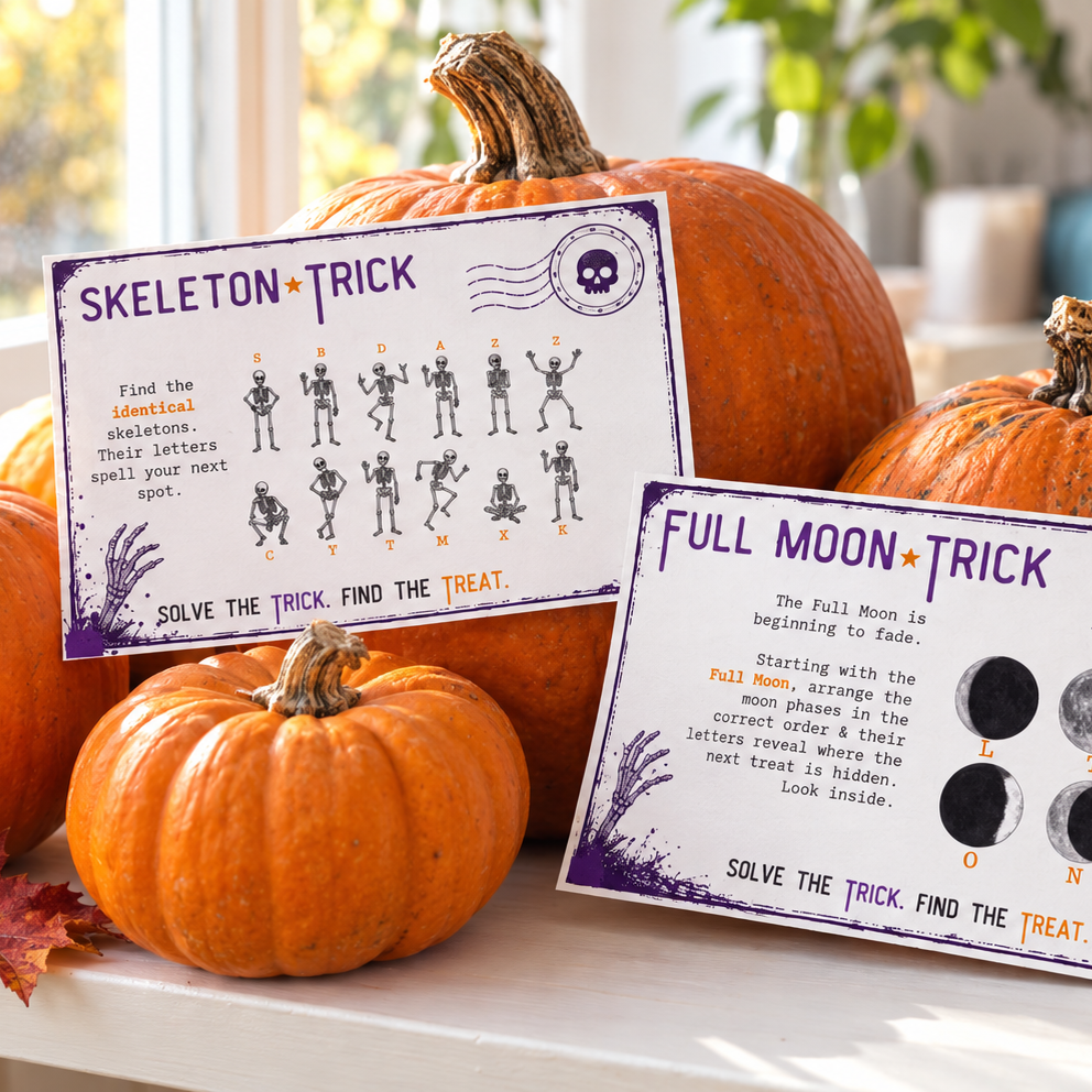 Two printable Halloween activity cards, 'Skeleton Trick' and 'Full Moon Trick', displayed on a table surrounded by pumpkins and autumn leaves in a cozy living room setting.